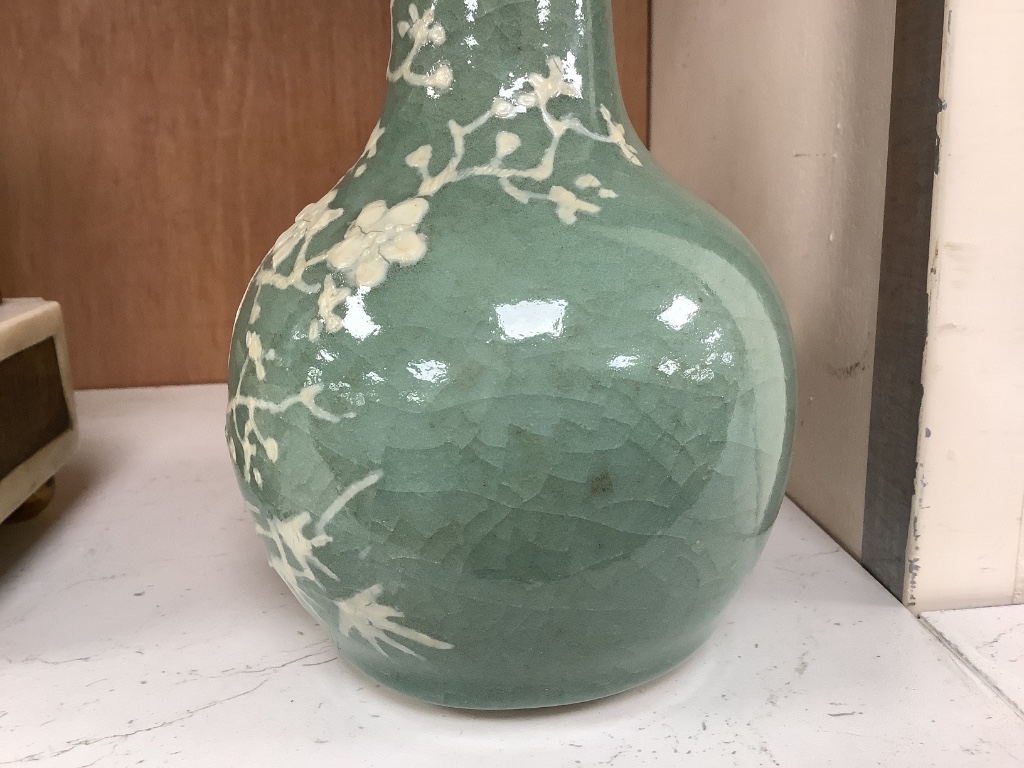 A Chinese celadon bottle vase with white slip decoration, 19th/20th century, height 20cm